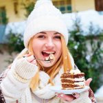 attractive-happy-young-woman-sitting-eating-dessert-cafe(1)